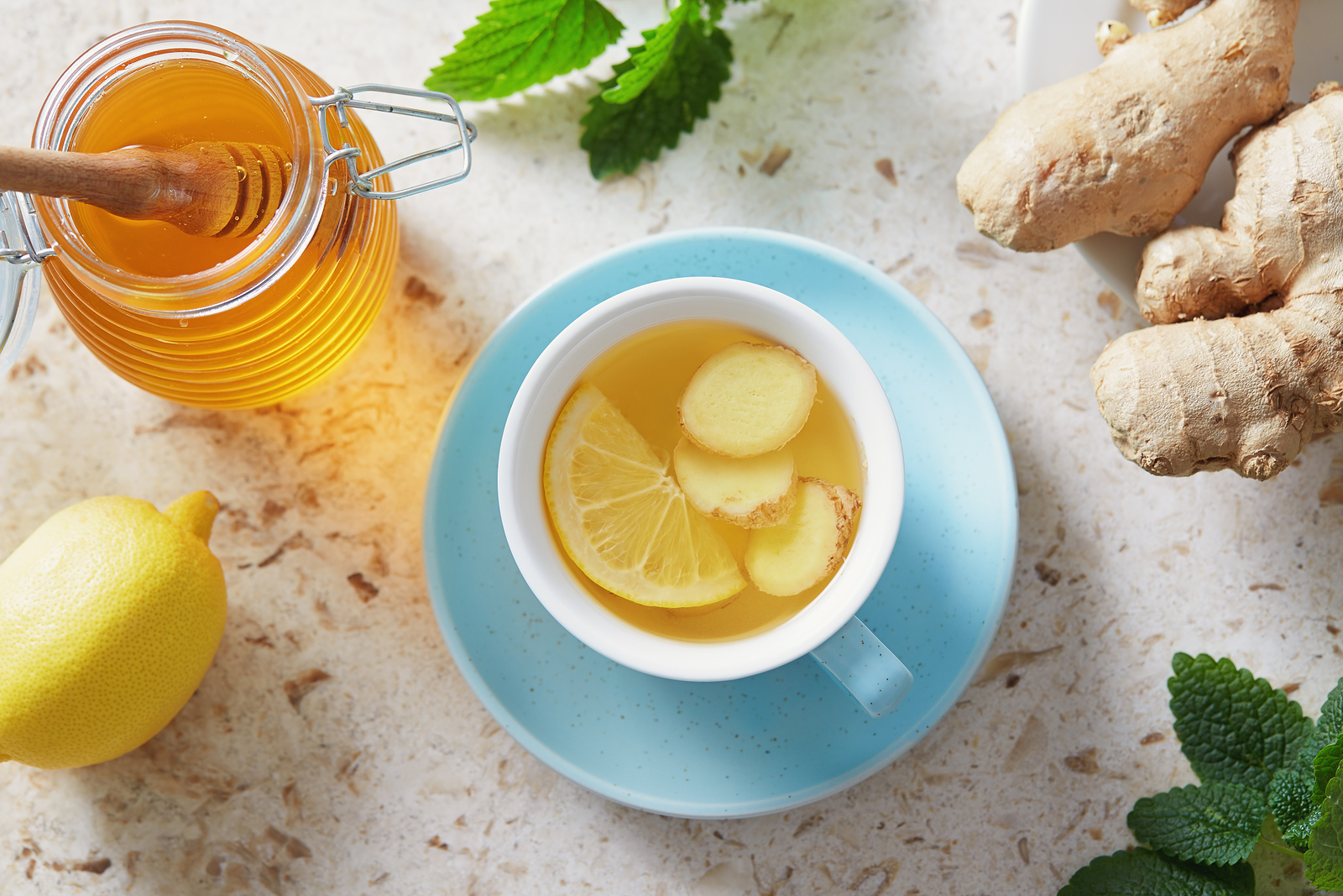 Lemon and ginger tea with honey Cup of hot honey lemon tea with fresh ginger root