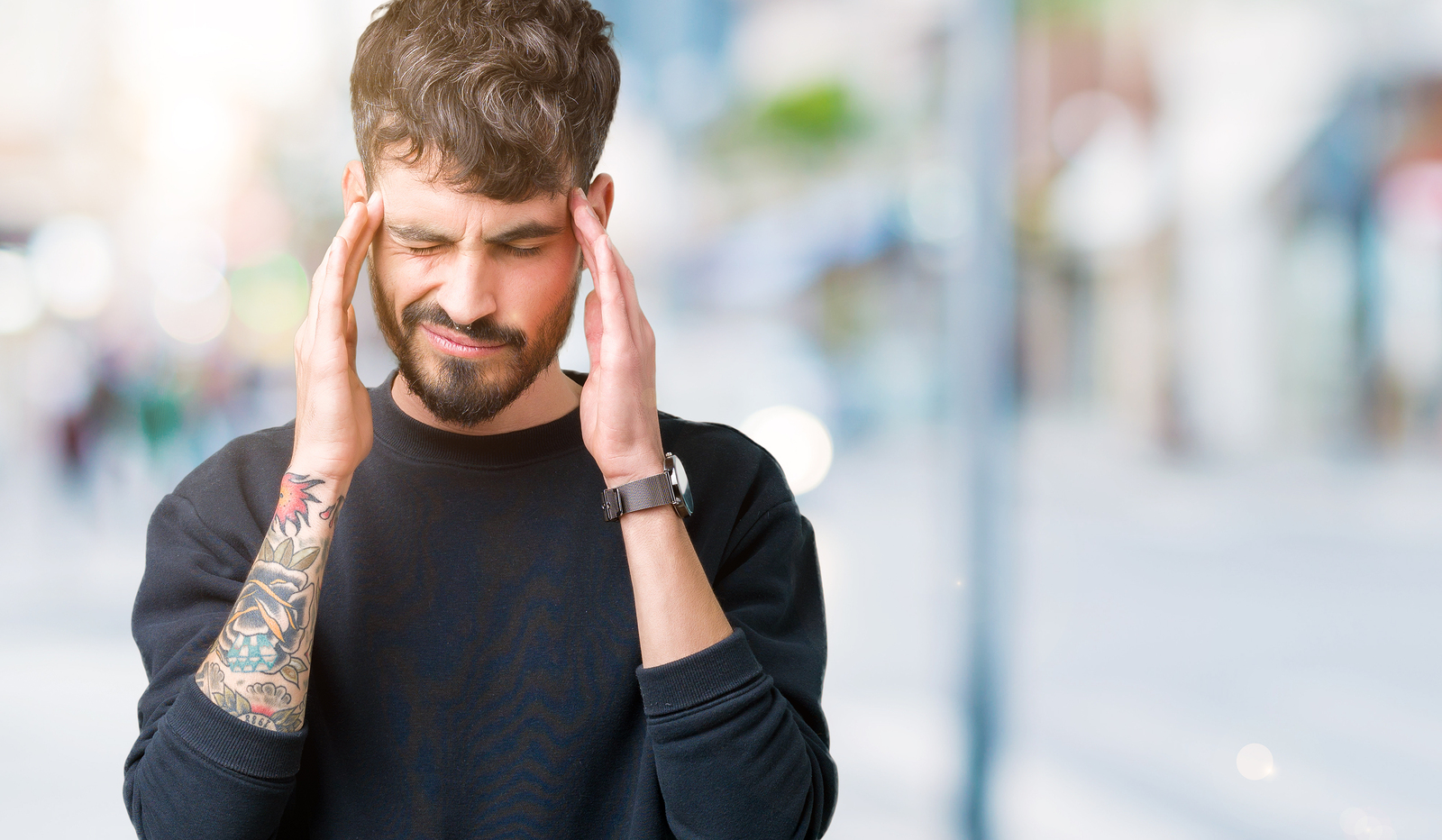 Young handsome man over isolated background with hand on head for pain in head because stress Suffering migraine