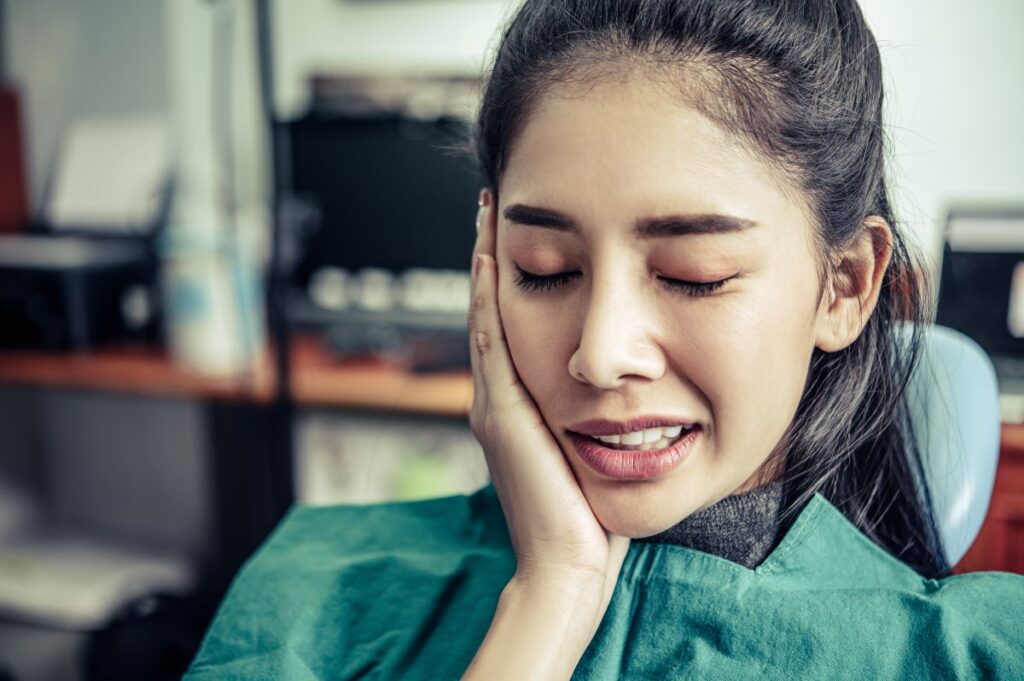 Woman with facial pain from TMJ