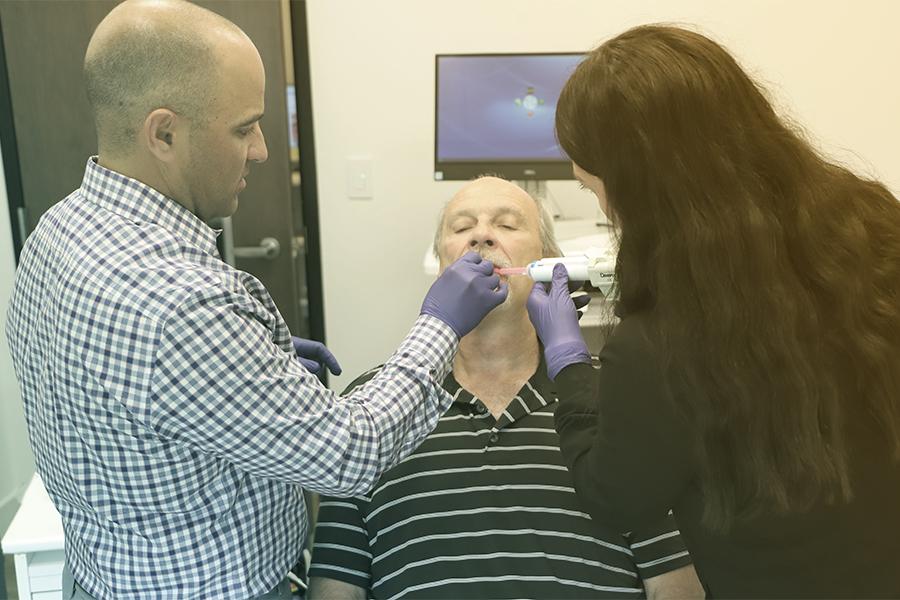 TMJ and Sleep Therapy staff capturing digital impressions of a patient's mouth